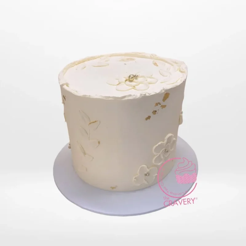 White on White Cake – Custom cake for elegant celebrations in Birmingham. White on White Cake – A custom cake with intricate white decorations, available at our cake shop Birmingham.