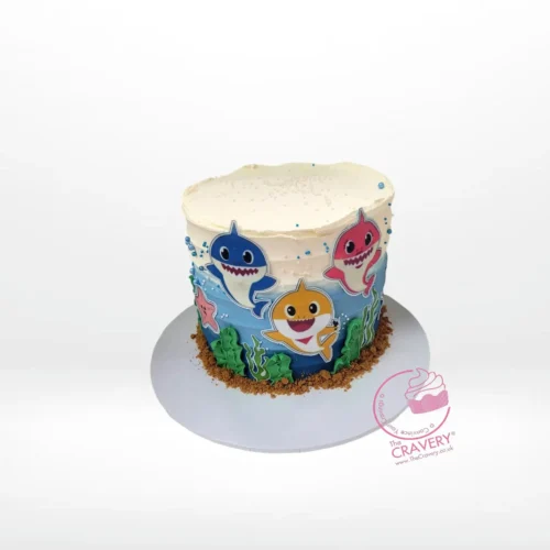 Babyshark Cake with Waves, themed blue cake with sea-inspired decorations and Baby Shark characters, from the best cake shop in Birmingham