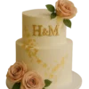 Buttercream wedding cake with gold initials and foil leaf