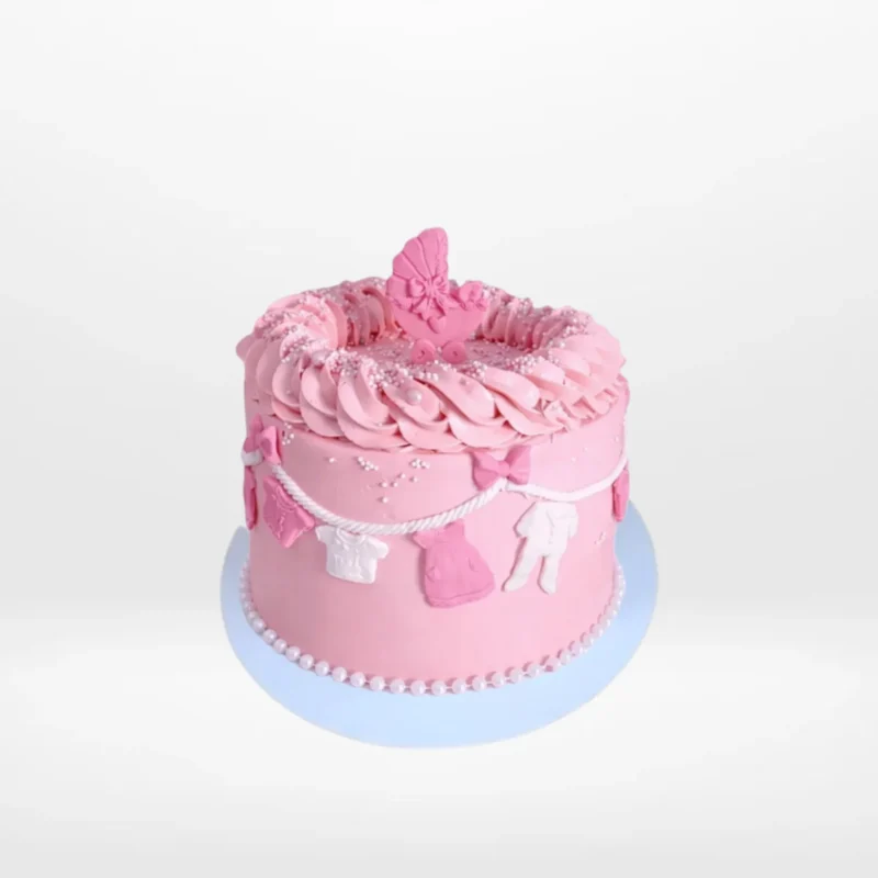 Babyshower Pink Clothes Line Cake by The Cravery | Cake Makers Solihull Pink Babyshower Cake decorated with clothes line theme, handcrafted by The Cravery Cake Makers in Solihull.