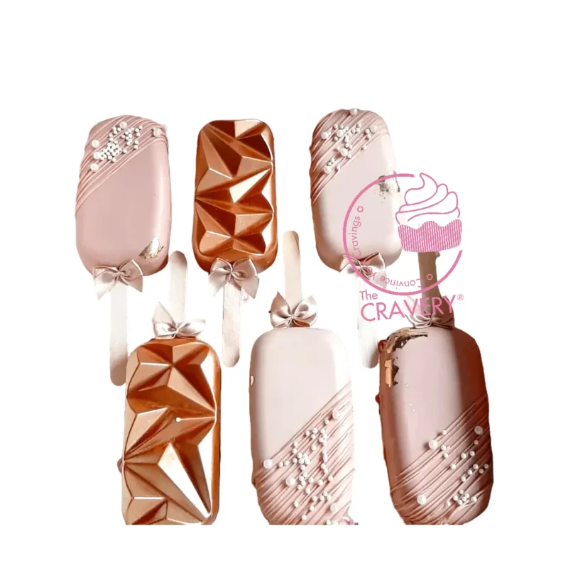 Blush Mini Cakesicles, Cakes Delivered Birmingham Blush coloured mini cakesicles decorated in soft romantic tones.
