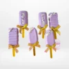 Mini cakesicles coated in chocolate and decorated with elegant designs.
