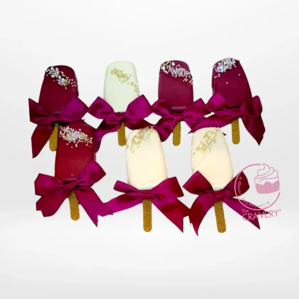 Festive mini Christmas cakesicles decorated with holiday designs.