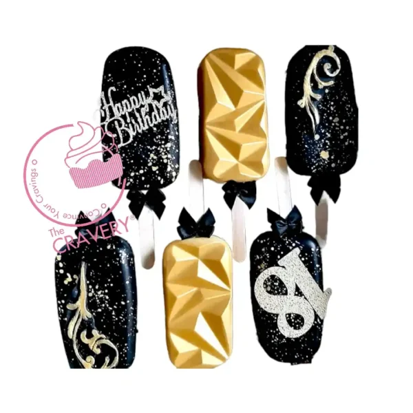 Crowned Cakesicles decorated with elegant crown toppers.