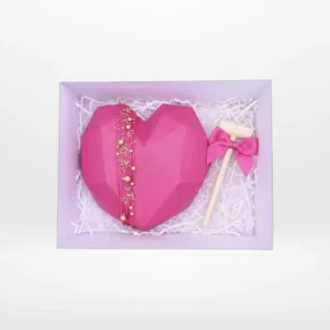 Smash chocolate heart with wooden hammer and hidden sweets inside.