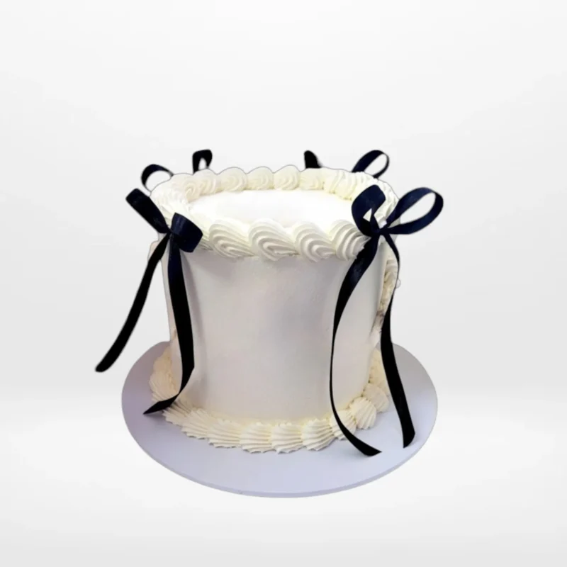Tall White Cake Birmingham White celebration cake with smooth buttercream finish made in Birmingham.