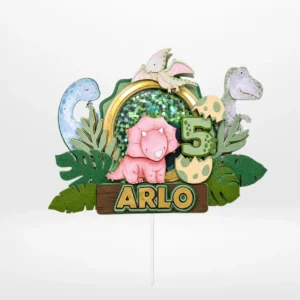 Dinosaurs cake topper with layered 3D shaker design, dinosaur characters, eggs, and jungle leaves from Cake Shop Dudley.